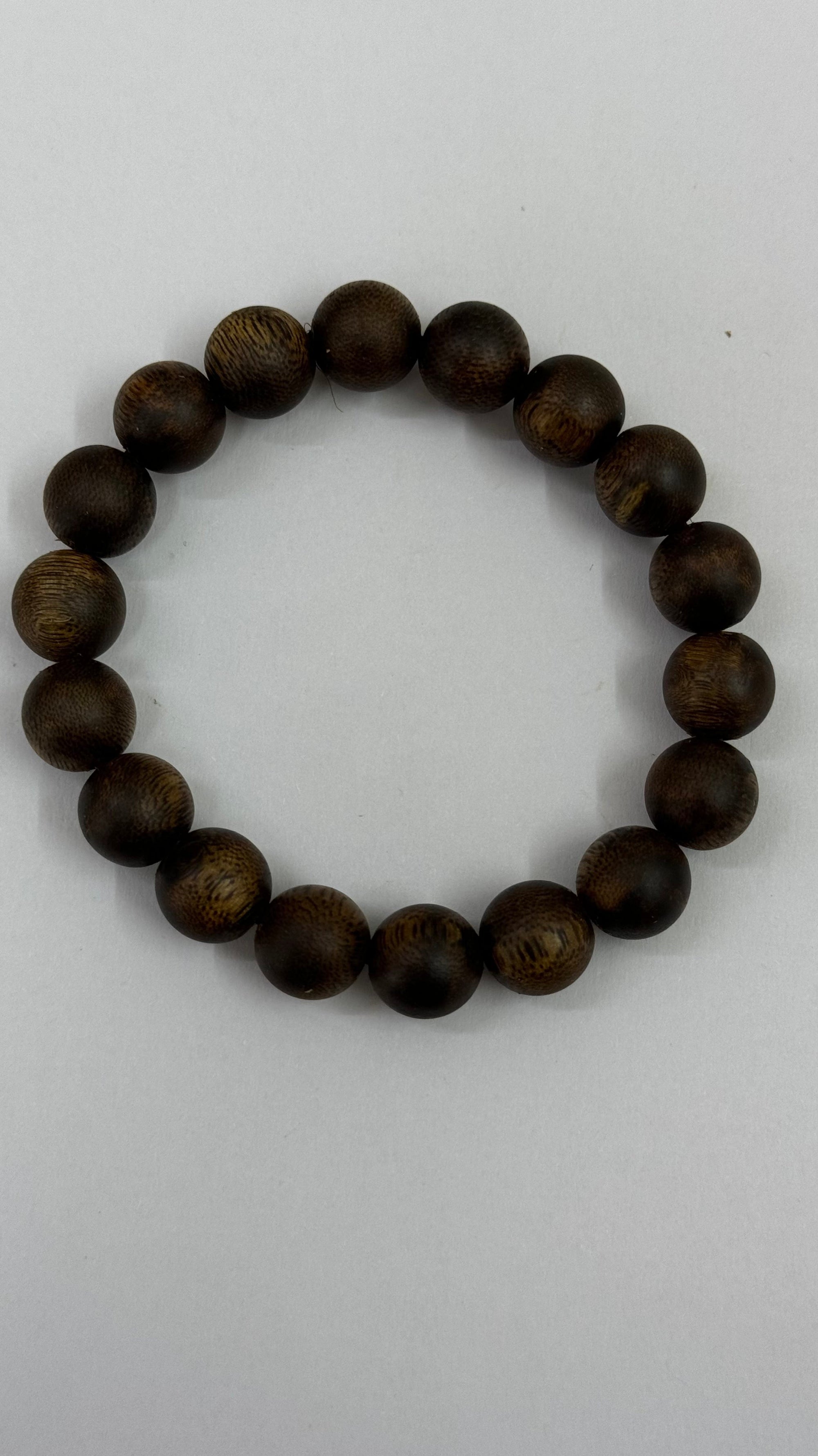 Dark brown agarwood bead bracelet displayed on a plain white surface
